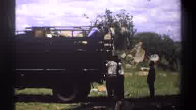 Lagos Nigeria (1969): Three People Pulling Car Truck Wagon Back Door Grass Floor