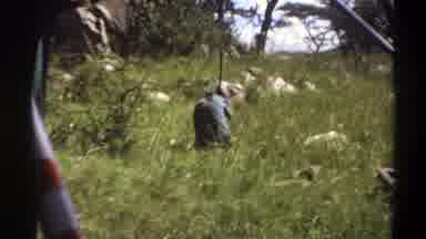 Lagos Nigeria (1969): A Man Is Sitting On The Grassy Ground And Digging
