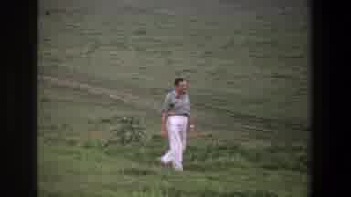 Pretoria South Africa (1969): A Man In White Pants Walking Through A Grassy Field