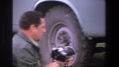 Pretoria South Africa (1969): Two Men Working On Fixing A Truck's Tire Surrounded