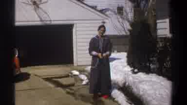 Cape Town South Africa (1969): Person Wearing Blue Robe Red Shoes Tosses Object In