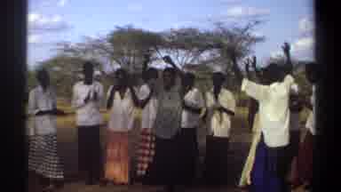 Khartoum Sudan (1969): Group Of People Wearing White Shirts Dancing On Clear Sunny