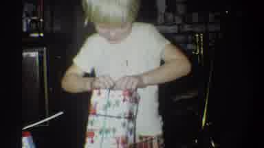 Troy New York USA (1973): Blond Child Wearing Pajamas In Living Room Unwraps