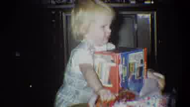 Troy New York USA (1973): Blonde Girl Excitedly Tears Open Her Christmas Gift In