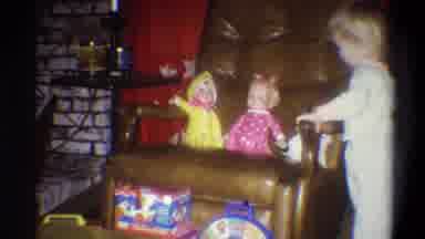 Troy New York USA (1973): Toddler Blond Girl Playing With Dolls On Armchair
