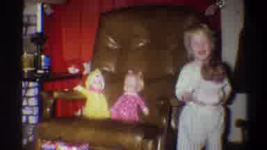 TROY NEW YORK USA-1973: Adorable Little Girl Gleefully Playing With 3 Baby Dolls