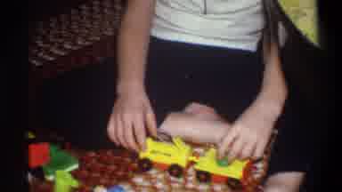 Troy New York USA (1973): Child Playing With Yellow Fisher Price People And Yellow