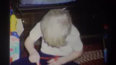 Troy New York USA (1973): Happy Child Playing And Fixing His White Toy Car At Home