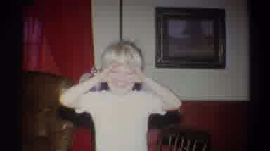 Troy New York USA (1973): A Boy Inside The Dining Room Playing With His Hands In