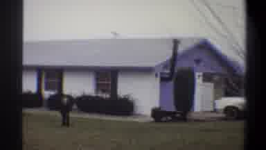 Troy New York USA (1973): Two Children Walking Toward Camera In Front Of A Small