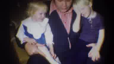 Troy New York USA (1973): A Dad Sitting With His Two Small Children As They Get