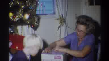 Troy New York USA (1973): Woman And Small Child Open Up A Gift Within A White Box