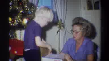 Troy New York USA (1973): An Older Woman And A Small Blonde Child Opening A Box