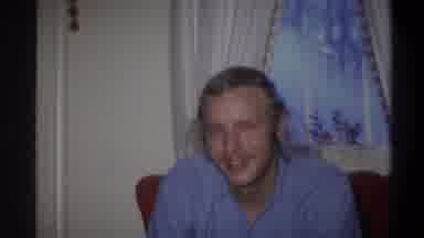 Troy New York USA (1973): Blond Blue Shirted Smiling Male Person Sitting On The