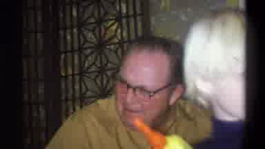 Troy New York USA (1973): Woman And Man Talking In A Living Room While A Young