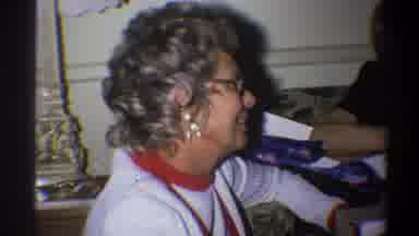 Troy New York USA-1973: Woman Wearing White Shirt and Glasses Sitting and Talking
