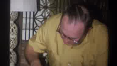 Troy New York USA (1973): A Mature Man Shows A Woman An Object He Is Holding While