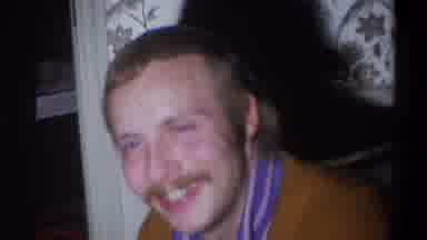 Troy New York USA (1973): A Man With Facial Hair Laughs And Smiles While Seated