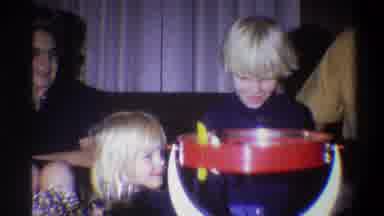 Troy New York USA (1973): A Boy And Girl Playing Together With A Toy In Some Party