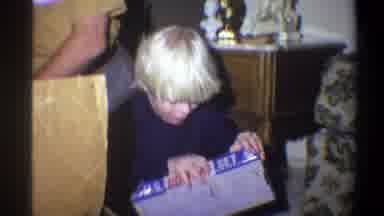 Troy New York USA (1973): Boy In Living Room Opening A Toy Box With Grandpa Trying