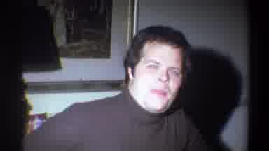 Troy New York USA (1973): A Man Is Talking Into The Camera As A Woman Turns Around