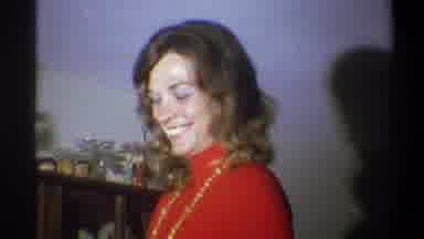 Troy New York USA (1973): Woman Smiling As She Puts Something On A Shelf Man
