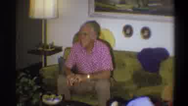Troy New York USA-1973: Elderly Man in Living Room on Green Couch