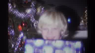Troy New York USA (1973): Young Child Shows Off Presents To Camera During