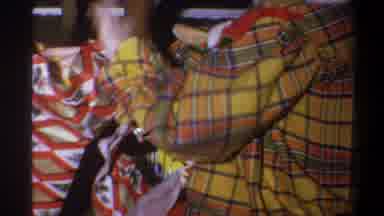 Troy New York USA (1973): Person Opening A Gift Package With A Striped Jacket And
