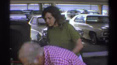 Troy New York USA (1973): Female Laughing As Man Smokes Cigarette