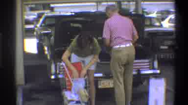 TROY NEW YORK USA-1973: A Couple Just Left The Market With Their Shopping And