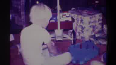 Troy New York USA (1973): Child Wearing White Plays With Toys Next To Christmas