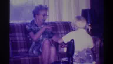 Troy New York USA (1973): An Elderly Woman Talks To A Blonde Child Opening A