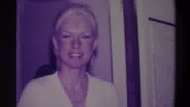 Troy New York USA (1973): A Woman Smiles Coyly In A Door Frame