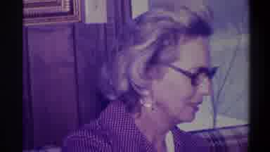 Troy New York USA (1973): Woman Wearing Glasses Gold Earrings Looks Down At Gold