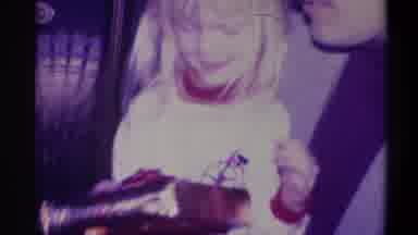 Troy New York USA (1973): Happy Young Girl Sitting On Father's Lap Opening A