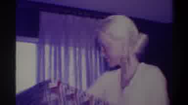 Troy New York USA (1973): Elderly Blonde Haired Women Picks Up Large Box And Then