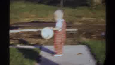 Gainsville Florida USA (1974): Baby Wearing Red Overalls Dancing On Pavement On