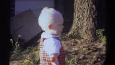 Gainsville Florida USA (1974): Toddler Blond Baby Standing Holding Toy Wand In A