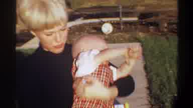 Gainsville Florida USA (1974): The Mother Is Holding Crying Baby At The Playground