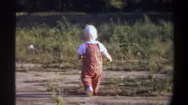 Gainsville Florida USA (1974): A Child Is Alone Playing In The Grassland And