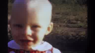GAINSVILLE FLORIDA USA-1974: Cute Baby Walking In Field Excited Parenthood
