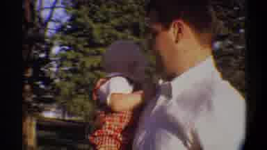 Gainsville Florida USA (1974): A Father With His Baby Son Playing In Front Of