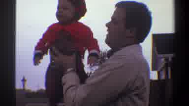 Gainsville Florida USA (1974): Dad Listing Hoisting Baby Boy Air Sky Laughing