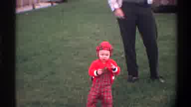Gainsville Florida USA (1974): A Small Child In Red Stumbles On The Grass
