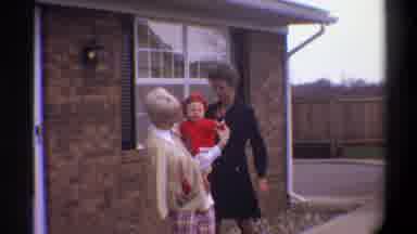 Gainsville Florida USA (1974): Blond Mother Smiles And Then Waves Her Baby's Arm