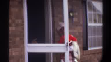 Gainsville Florida USA (1974): A Blonde Woman Carries A Baby Through The Front