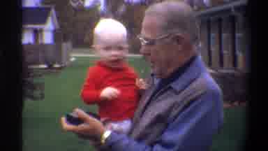 Gainsville Florida USA (1974): Old Man Holding A Baby Talking And Walking Around A