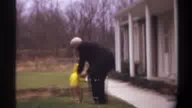 Gainsville Florida USA (1974): Older Gentleman Sweetly Picking Up A Small Toddler
