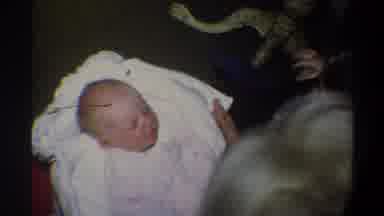 Gainsville Florida USA (1974): Grand Mother Wrapping Grand Child As Older Sibling
